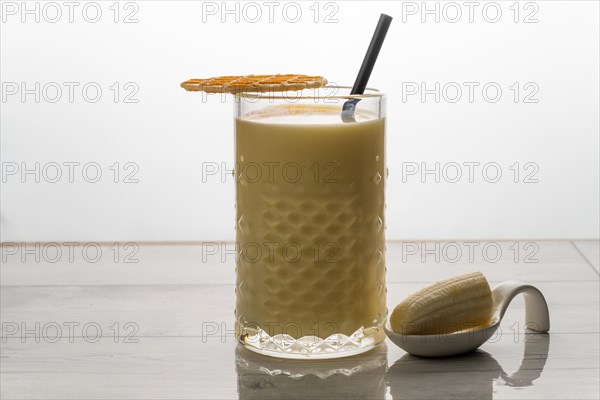 Banana milkshake with fresh fruit and cookie white background and copy-space