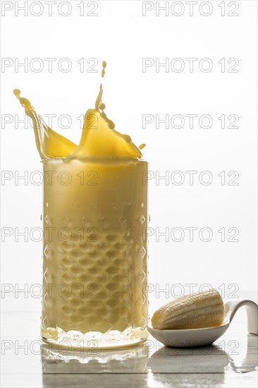 Banana smoothie with fresh fruit and cookie splash effect