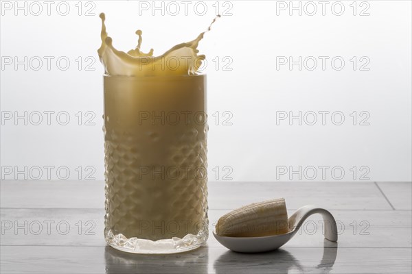 Banana smoothie with fresh fruit and cookie splash effect