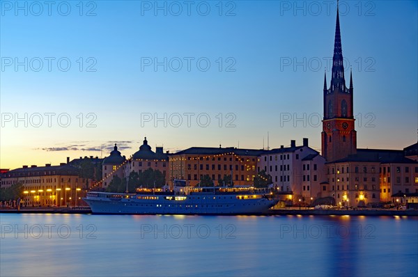 Illuminated harbour front at blue hour