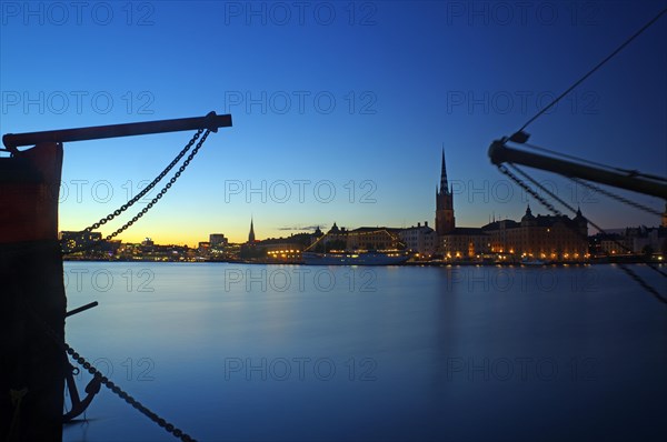 Illuminated harbour front at blue hour