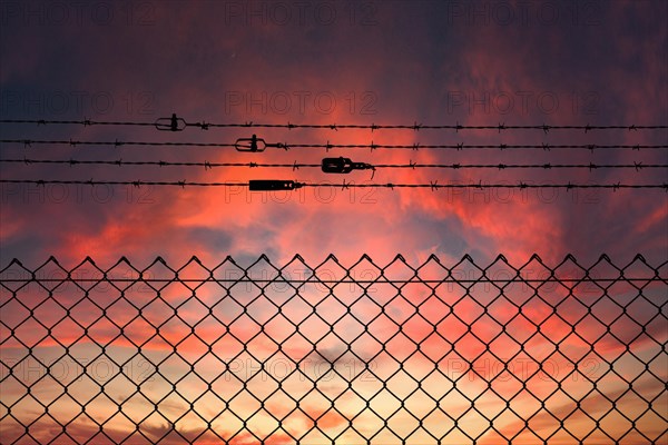 Chain link fence with additional barbed wire