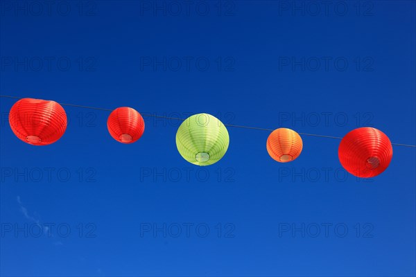 Colourful lanterns hanging on a line over the street