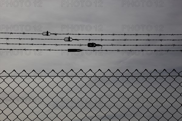 Chain link fence with additional barbed wire