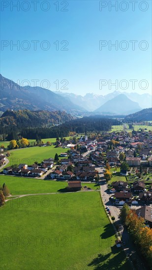 Aerial view of Fischen im Allgaeu with a view of the parish church of St Verena
