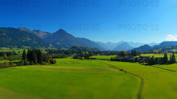 Aerial view of Fischen im Allgaeu with a view of the parish church of St Verena