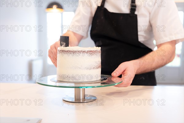 Hands of a man bakes a red velvet cake at home