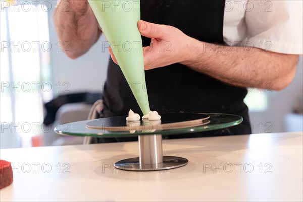 Hands of a man bakes a red velvet cake at home