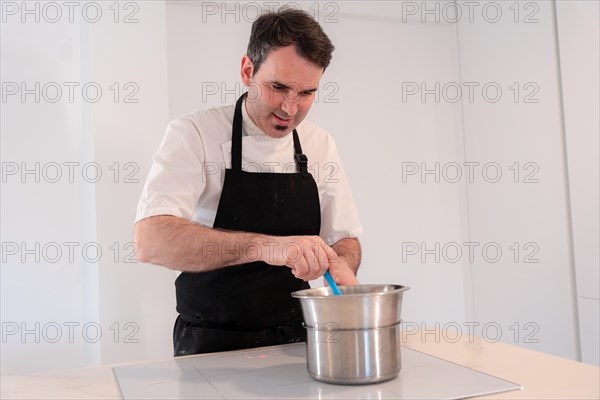 A man baker cooking a red velvet cake at home