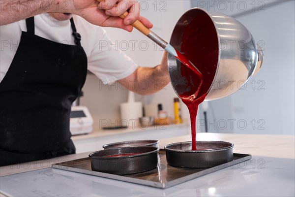 Hands of a man cooking a red velvet cake at home