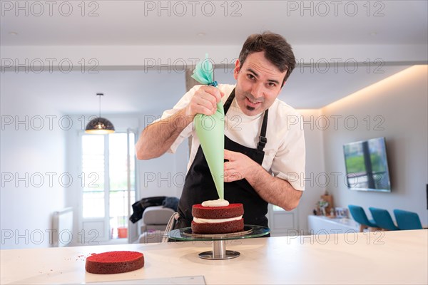 A challenger man bakes a red velvet cake at home