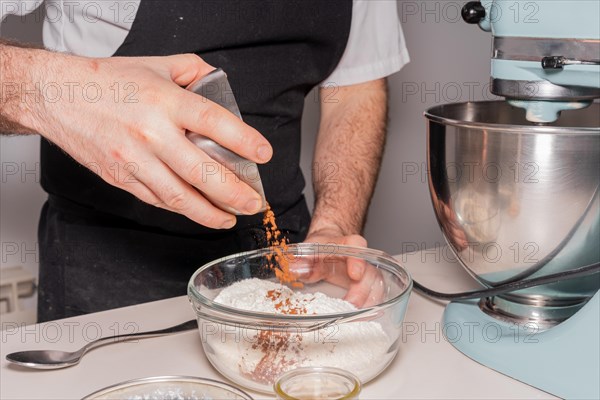 A man baker cooking a red velvet cake at home