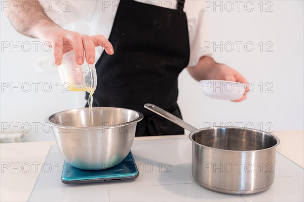 Hands of a man cooking a red velvet cake at home