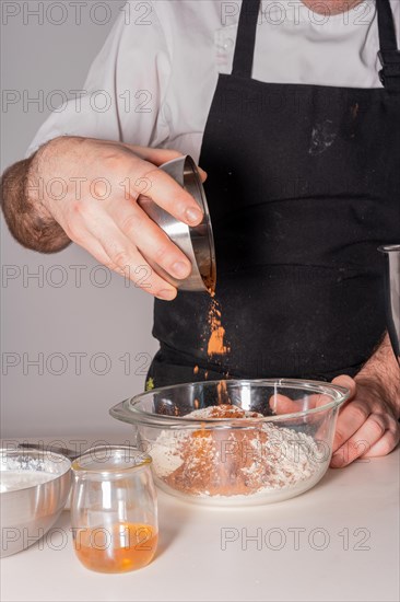 A man baker cooking a red velvet cake at home