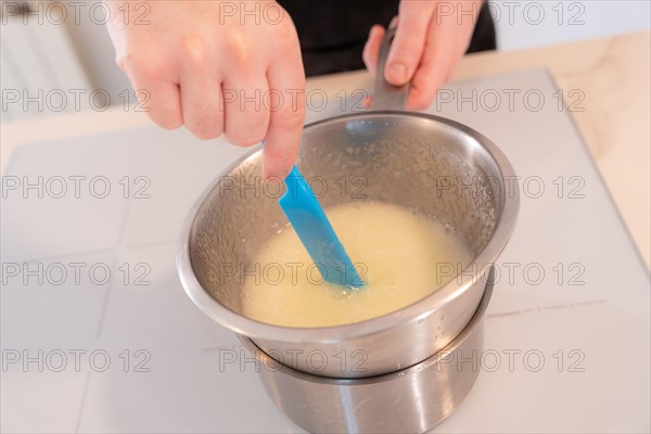 Hands of a man cooking a red velvet cake at home