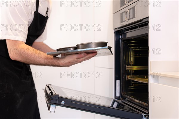 Hands of a man cooking a red velvet cake at home