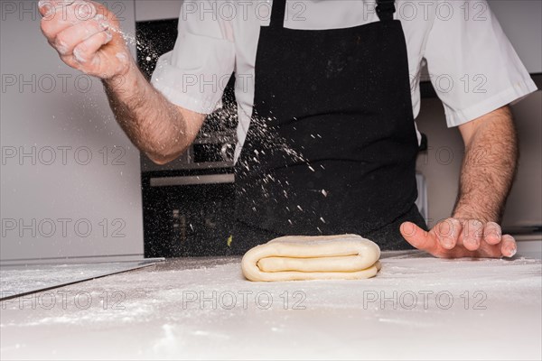 Confectioner man cooking homemade croissants