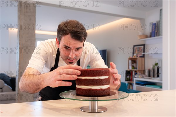 A challenger man bakes a red velvet cake at home