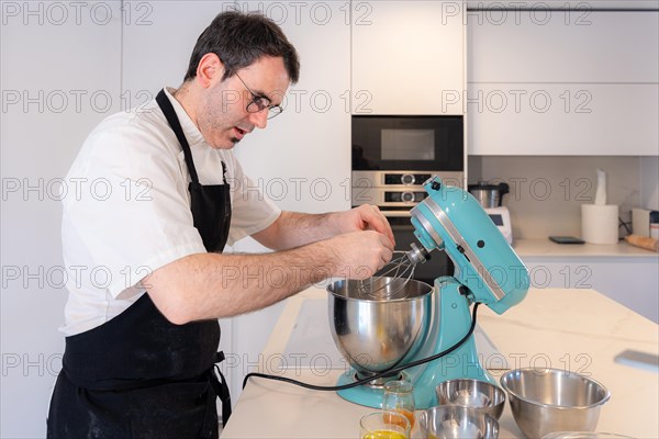 A man baker cooking a red velvet cake at home