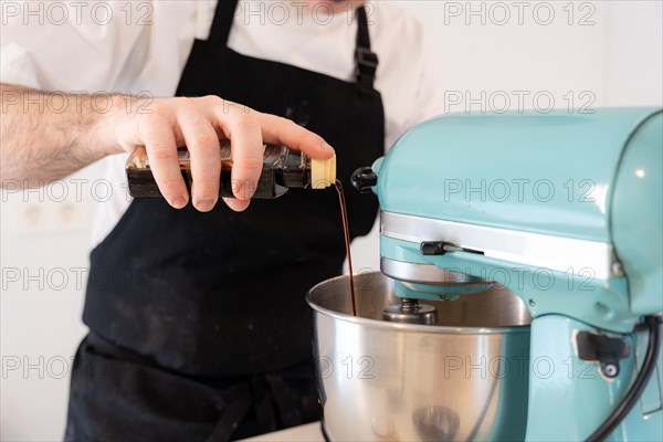 A man baker cooking a red velvet cake at home