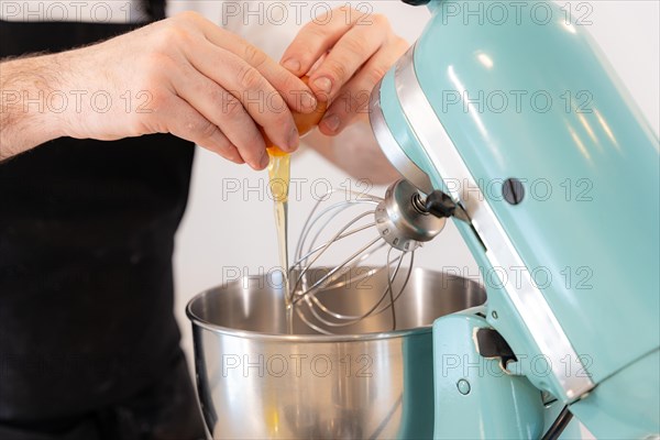 A man baker cooking a red velvet cake at home