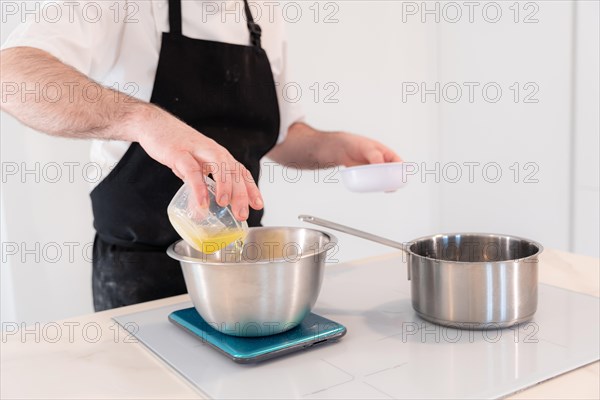 Hands of a man cooking a red velvet cake at home