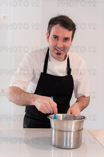 A man baker cooking a red velvet cake at home