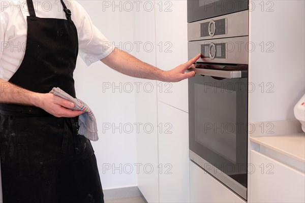 A man baker cooking a red velvet cake at home