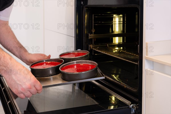 Hands of a man cooking a red velvet cake at home