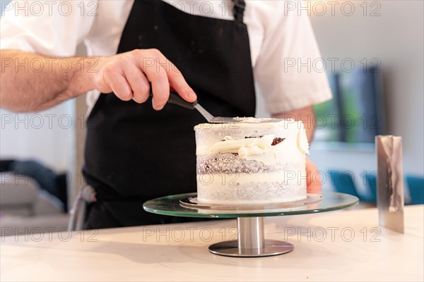 Hands of a man bakes a red velvet cake at home