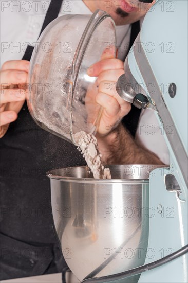 A man baker cooking a red velvet cake at home