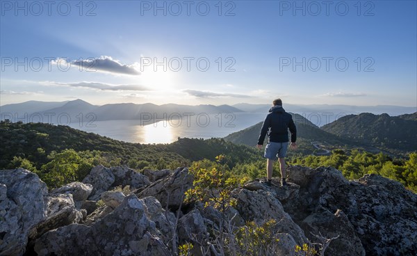 Hiker looking over volcanic peninsula Methana