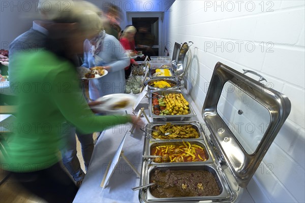 Guests at the Persian buffet at a party