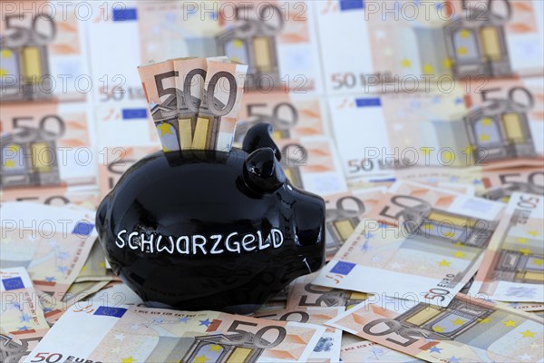 Piggy bank for black money and 50 euro banknotes