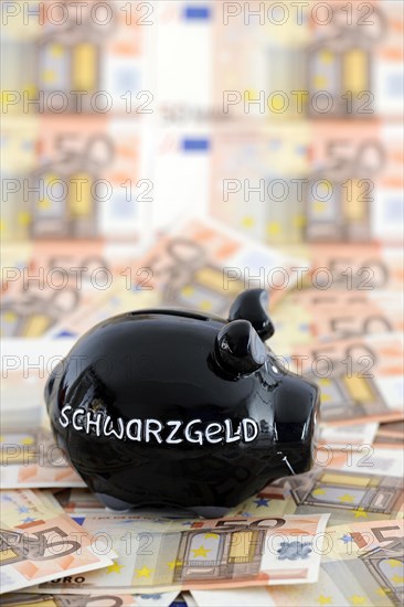 Piggy bank for black money and 50 euro banknotes