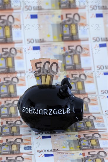 Piggy bank for black money and 50 euro banknotes