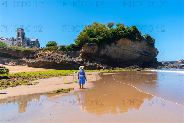 An elderly woman enjoying the holidays on the beach in Biarritz