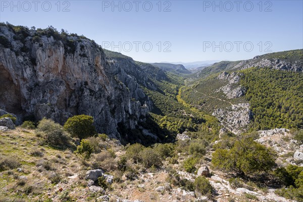 View into a valley with rock walls in the mountains