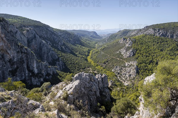View into a valley with rock walls in the mountains