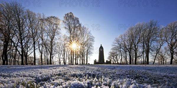 Hoarfrost on the Hohenstein with mountain monument in the backlight