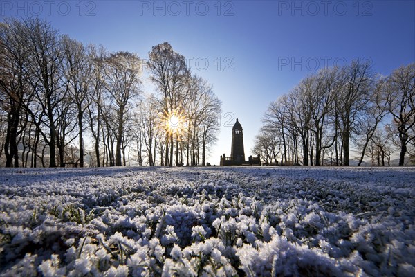 Hoarfrost on the Hohenstein with mountain monument in the backlight