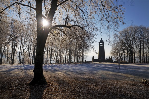 Hoarfrost on the Hohenstein with mountain monument in the backlight