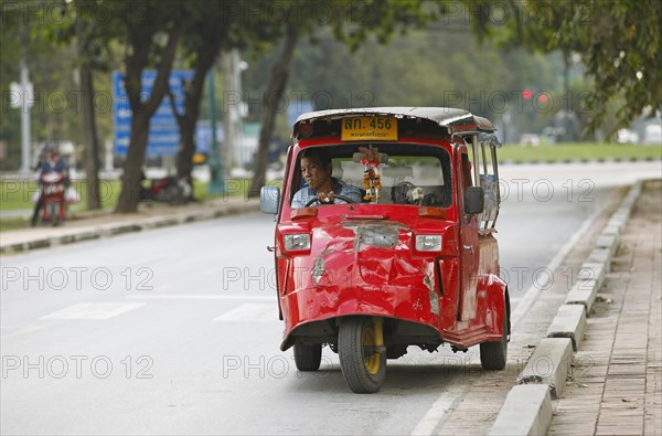 Red tuk tuks on the street