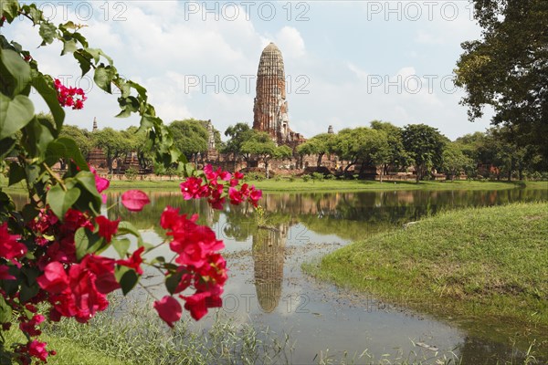 Prang of Wat Phra Ram reflected in the park lake