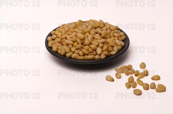 Close-up of fresh peeled pine nuts isolated