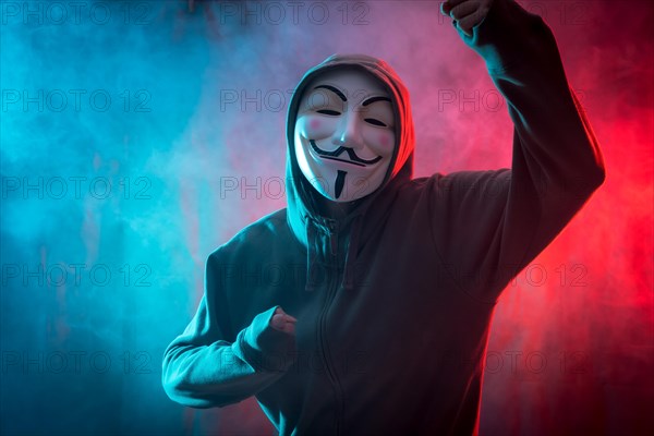 Hacker with anonymous mask with a symbol of fight