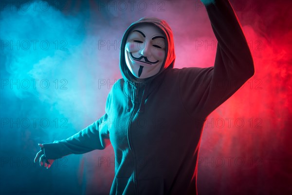 Hacker with anonymous mask with a symbol of fight