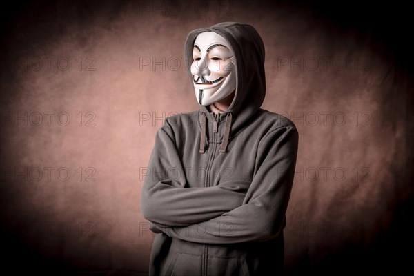 Man wearing anonymous mask with sweatshirt