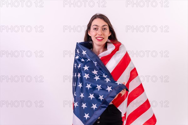 Caucasian woman embracing usa flag isolated on a white background