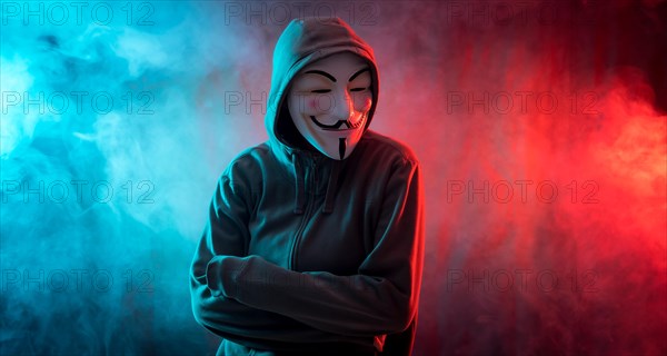 Hacker with anonymous mask with arms crossed with a menacing look